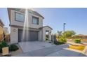 Well-maintained home featuring a two-car garage, a paved driveway and desert landscaping at 10013 E Trent Ave, Mesa, AZ 85212