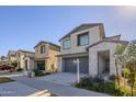 Charming home with a two-car garage, desert landscaping, and neighboring houses at 10013 E Trent Ave, Mesa, AZ 85212