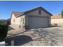 Single-story home featuring a two-car garage, low maintenance yard, and neutral paint at 11342 E Queensborough Ave, Mesa, AZ 85212