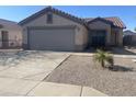 Lovely single-story home with a two-car garage and low maintenance desert landscaping at 11342 E Queensborough Ave, Mesa, AZ 85212