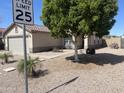 Charming single-story home featuring desert landscaping, mature trees, and neutral colors at 11342 E Queensborough Ave, Mesa, AZ 85212