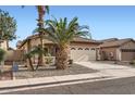 Attractive home with lush palm trees, gravel landscaping, and a convenient two-car garage at 11725 W Jefferson St, Avondale, AZ 85323