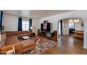 Spacious living room with leather sectional sofa, patterned rug, and large windows at 1822 N Laurel Ave, Phoenix, AZ 85007