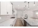 Well-lit kitchen with quartz countertops, a large island, stainless steel appliances, and ample storage at 20273 W Monterey Way, Buckeye, AZ 85396