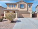 Charming two-story home featuring a well-maintained front yard and a spacious two-car garage at 21354 N Denver Ct, Maricopa, AZ 85138