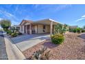 Quaint single-Gathering home boasting a covered carport, xeriscaped yard, and small porch at 2263 N Trekell Rd # 81, Casa Grande, AZ 85122