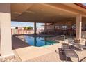 Community pool with shaded seating, lounge chairs, and brick pavers for residents at 2263 N Trekell Rd # 81, Casa Grande, AZ 85122