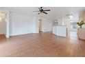 Spacious living room featuring bright, neutral paint, wood-look floors, and a ceiling fan at 2323 W Carson Rd, Phoenix, AZ 85041