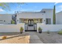 Inviting stucco home featuring a gated entrance, upper balcony, and desert-style landscaping at 24417 N 87Th St, Scottsdale, AZ 85255