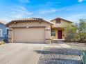 Charming single-Gathering home with a two-car garage and desert landscaping at 25879 W Elizabeth Ave, Buckeye, AZ 85326