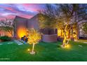 Backyard area featuring a lush lawn, mature trees, and a seating area at 30600 N Pima Rd # 49, Scottsdale, AZ 85266