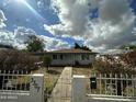 Inviting single-story home featuring secure fencing and well-maintained landscaping at 3307 E Yale St, Phoenix, AZ 85008