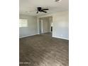 Bright living room featuring sleek flooring, fresh paint, and modern ceiling fan at 3307 E Yale St, Phoenix, AZ 85008