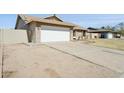 Single-story home with a large driveway and convenient two-car garage at 4634 W Aire Libre Ave, Glendale, AZ 85306