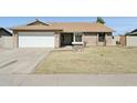 Charming single-story home with a well-maintained yard and two-car garage at 4634 W Aire Libre Ave, Glendale, AZ 85306