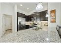 Modern kitchen featuring granite countertops, stainless steel appliances, and dark cabinetry at 4777 S Fulton Ranch Blvd # 1103, Chandler, AZ 85248