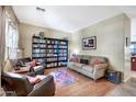 Inviting living room with a cozy seating area, built-in bookcase, and neutral decor at 6523 S 34Th Dr, Phoenix, AZ 85041