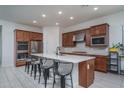 Stylish kitchen featuring stainless steel appliances, a large center island, and ample cabinet space for storage and organization at 7250 N 80Th Ln, Glendale, AZ 85303