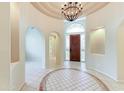 Grand foyer boasting tile flooring, high ceilings, and an elegant chandelier at 7722 E Fledgling Dr, Scottsdale, AZ 85255