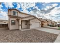 Charming two-story home with a large two car garage, neutral color scheme and low maintenance gravel yard at 833 W Cholla St, Casa Grande, AZ 85122