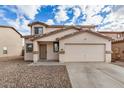 Charming two-story home with a large two car garage, neutral color scheme and low maintenance gravel yard at 833 W Cholla St, Casa Grande, AZ 85122