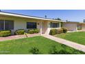 Inviting home exterior with lush landscaping, creating a welcoming and serene atmosphere at 9231 N 111Th Ave, Sun City, AZ 85351