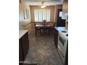 Warm dining area adjacent to the kitchen featuring tiled floors and a window, offering ample natural light at 10112 N 96Th Ave # A, Peoria, AZ 85345