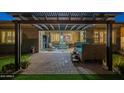 Inviting outdoor space with a covered patio, lush greenery, and a relaxing seating area at 10246 W Oberlin Way, Peoria, AZ 85383
