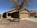 Charming single-story home with a well-maintained front yard and a two-car garage at 12046 W Scotts Dr, El Mirage, AZ 85335