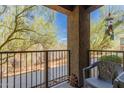 Charming balcony with wrought iron railing and views of desert landscaping at 12050 N Panorama Dr # 104, Fountain Hills, AZ 85268