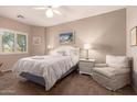 Serene bedroom with natural light, comfortable queen bed, and relaxing sitting area at 12050 N Panorama Dr # 104, Fountain Hills, AZ 85268