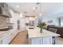 Modern kitchen with white cabinetry, a center island, stainless steel appliances, and open layout at 12117 W Luxton Ln, Avondale, AZ 85323