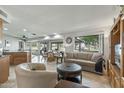 Inviting living room featuring large windows with views of the golf course at 12822 W Ballad Dr, Sun City West, AZ 85375