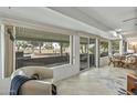 Enclosed patio featuring comfortable seating, sliding glass doors, and golf course views at 12822 W Ballad Dr, Sun City West, AZ 85375