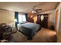 Bedroom featuring carpet, a ceiling fan, and a dresser at 15001 W Camdon Dr, Casa Grande, AZ 85194
