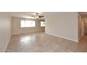 Well-lit living room with large windows and neutral tile flooring, perfect for relaxation at 1966 E Pebble Beach Dr, Tempe, AZ 85282