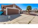 Charming single-Gathering home featuring a two-car garage, desert landscaping and a lush palm tree at 19801 N 6Th Pl, Phoenix, AZ 85024