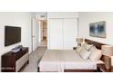 This is a cozy bedroom with a modern dresser, TV, and serene decor at 2121 S Pennington -- # 58, Mesa, AZ 85202