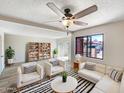 Bright living room featuring modern furnishings, stylish decor, and a sliding door to the back at 2121 S Pennington -- # 58, Mesa, AZ 85202