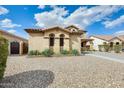 Charming two-story home features desert landscaping and a long, paved driveway at 21366 E Alyssa Rd, Queen Creek, AZ 85142