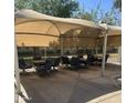 Inviting shaded patio area with tables and chairs, perfect for outdoor gatherings and relaxation at 2605 W Rose Lane -- # B201, Phoenix, AZ 85017