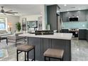 Modern open-concept kitchen features an island with seating and stainless steel appliances at 2818 E Malapai Dr, Phoenix, AZ 85028