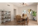 Dining room with wood-look floors, a ceiling fan, shelving and a wooden table with seating for six at 333 N Pennington Dr # 63, Chandler, AZ 85224