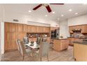 Spacious kitchen with wood cabinets, granite countertops, stainless steel appliances and an island with seating at 333 N Pennington Dr # 63, Chandler, AZ 85224