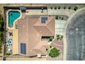 Aerial view of home with swimming pool, solar panels, covered patio, and low maintenance landscaping at 3818 N Kalispell Ct, Casa Grande, AZ 85122