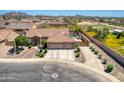 Aerial view of a desert home with a large driveway, desert landscaping, and backyard pool at 3818 N Kalispell Ct, Casa Grande, AZ 85122