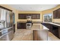 Well-equipped kitchen featuring stainless steel appliances, granite countertops, and dark wood cabinets at 4617 E Montgomery Rd, Cave Creek, AZ 85331