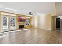 Neutral-toned living room with tile floors, a fireplace, a ceiling fan, and patio access at 4617 E Montgomery Rd, Cave Creek, AZ 85331