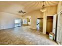 Spacious living room with neutral walls, tile flooring, a ceiling fan, and glass sliding doors leading to the exterior at 5040 N 69Th Dr, Glendale, AZ 85303