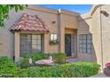 Inviting front porch with wrought iron seating area, flower box, and charming front door at 5505 E Mclellan Rd # 41, Mesa, AZ 85205